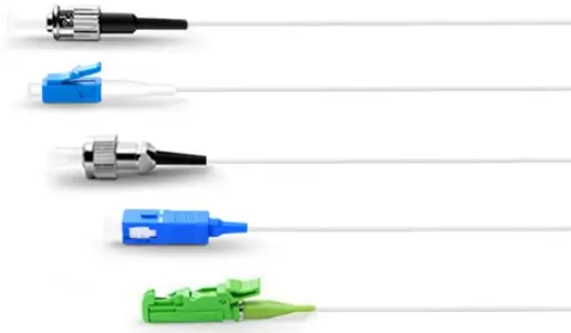 Five fiber pigtails with different connector ends are aligned horizontally, each extending to a bare fiber tail.
