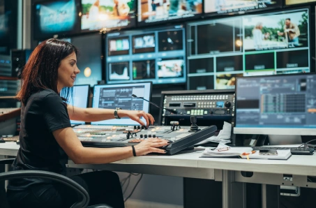 Operator works at a video control desk with multiple monitors, matching the SDI module section on video signal transport.
