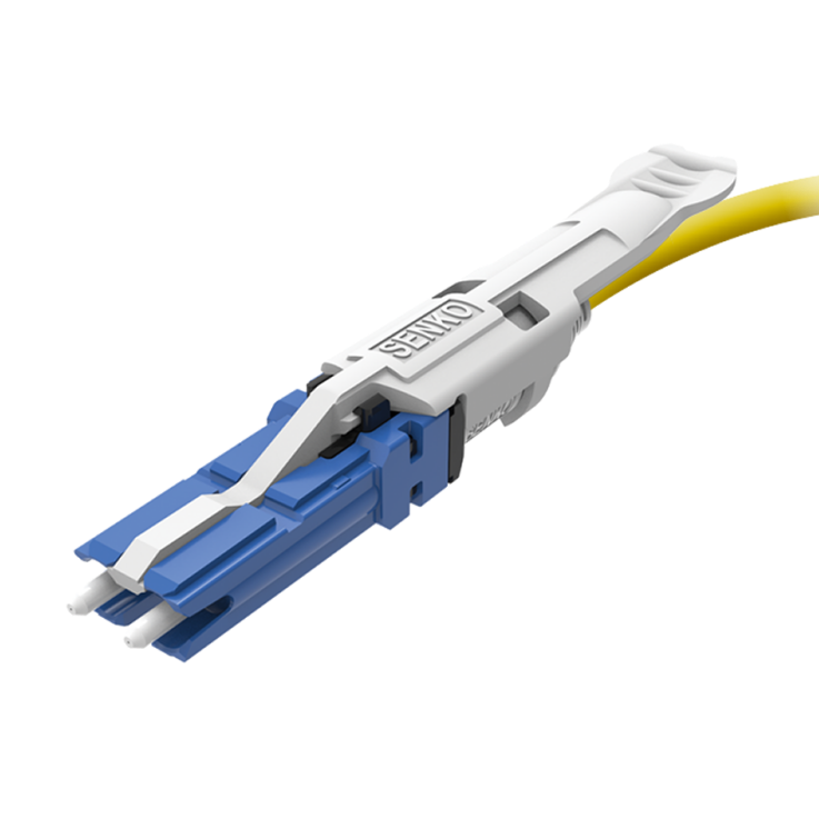 Compact duplex CS fiber connector with two narrow blue connector bodies and a white cable boot.