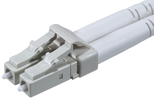 Duplex LC fiber connector with two gray latch housings and parallel fiber cables shown in a close-up view.
